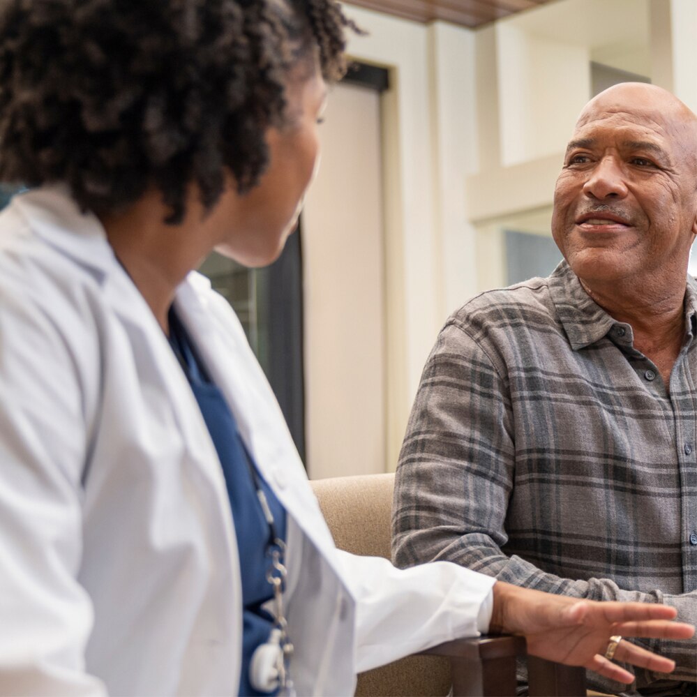 A patient discusses his prescription options with his clinician.
