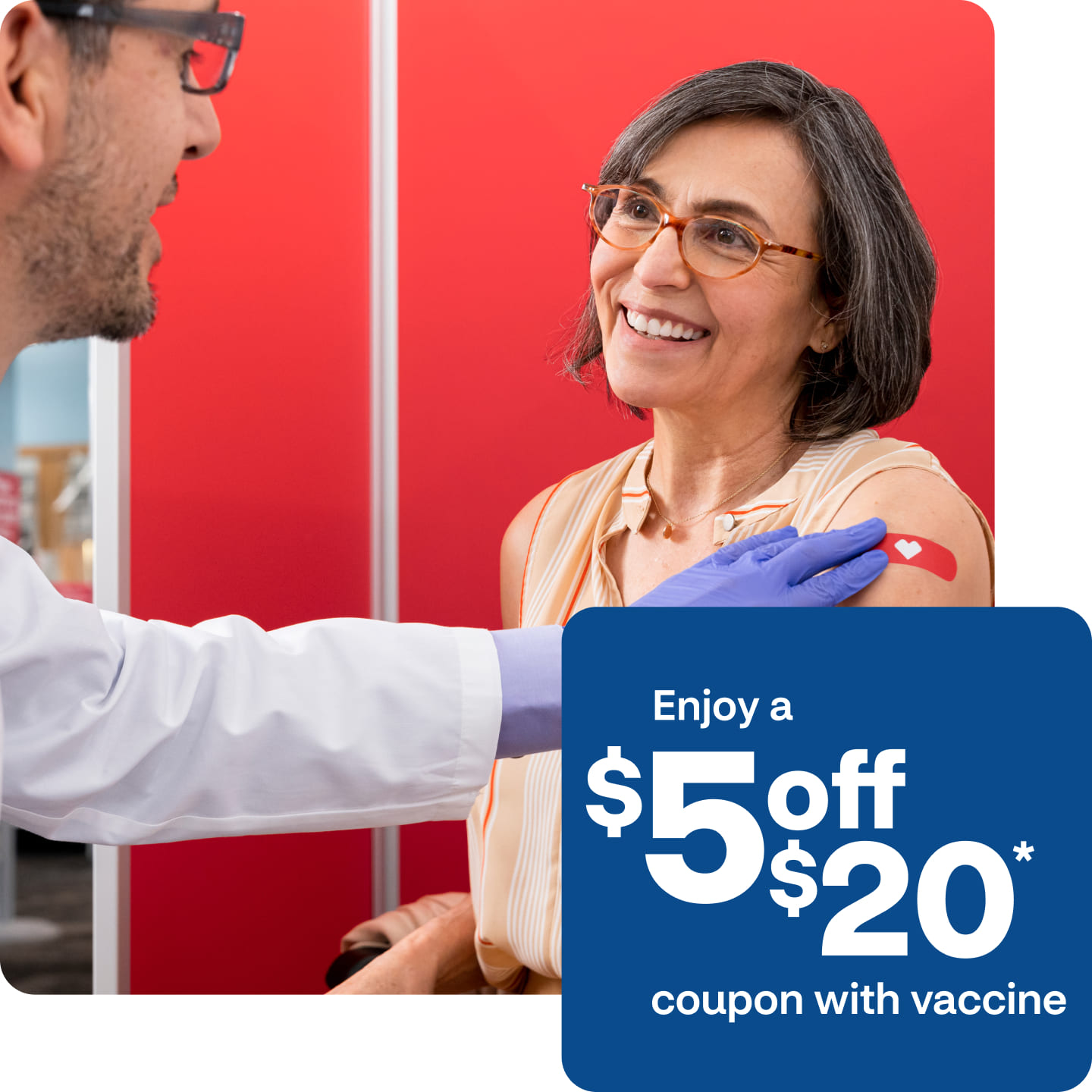 An older patient smiles as a provider places a bandage on their arm after getting a pneumococcal pneumonia vaccine.