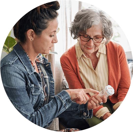An older adult talks about their prescriptions with their adult daughter.