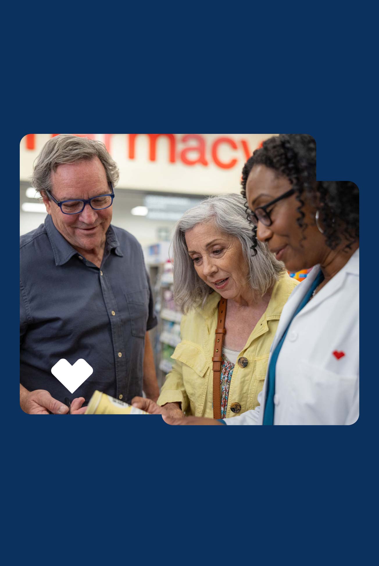 A CVS pharmacist provides a consultation for a couple.